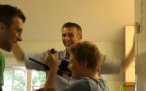 Sarah filming Eddie and Malcolm using Steady Wings Using steady wings Sarah films Eddie and Malcolm in the kitchen of Cana House