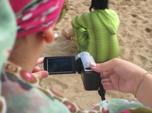 Filming at the beach during a participatory video workshop