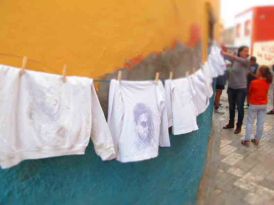 Young People's Performance: Faces on hanging shirts